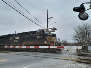 a train traveling down train tracks next to a traffic light